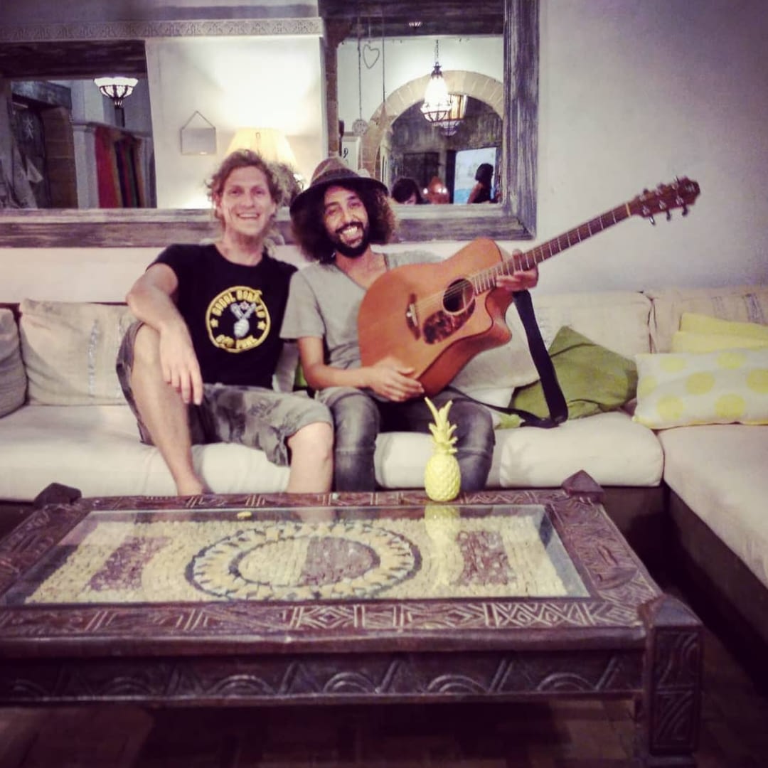 Ady and simo on the couch after recording sessions with guitar | Hit the road music studio